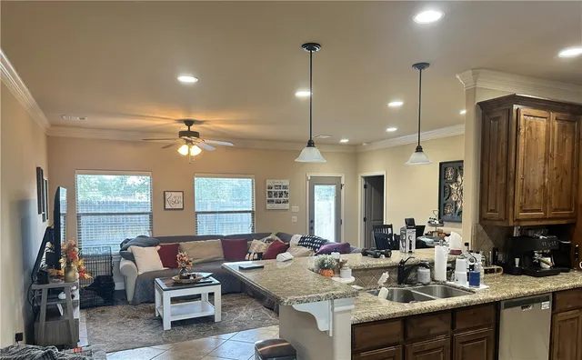 a kitchen with a sink dining table and chairs