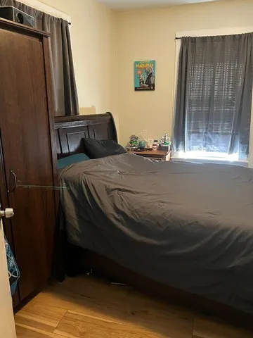 a bedroom with a bed and a mirror