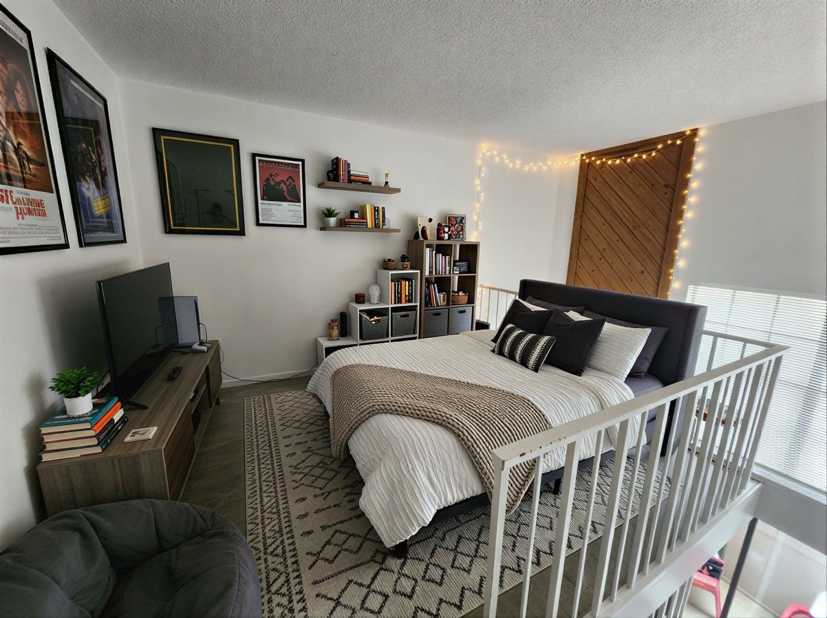 701 West 25th Street, Unit 1 Austin, TX 78705 - Photo 1 of 7 a bedroom with furniture and a flat screen tv