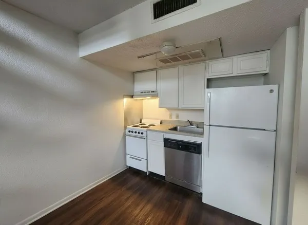 a kitchen with stainless steel appliances a refrigerator and a stove top oven