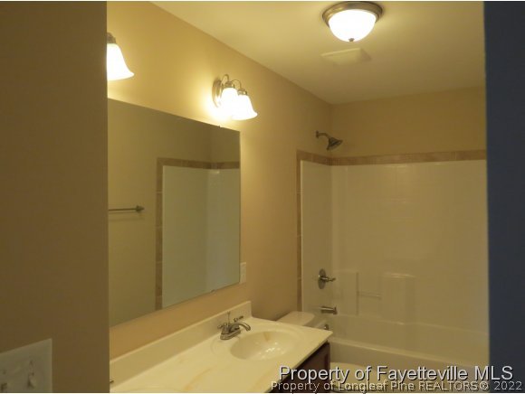 44 Golden Rod (lot 65) Cir Spring Lake Spring Lake, NC 28390 - Photo 12 of 13 a bathroom with a sink shower and a mirror