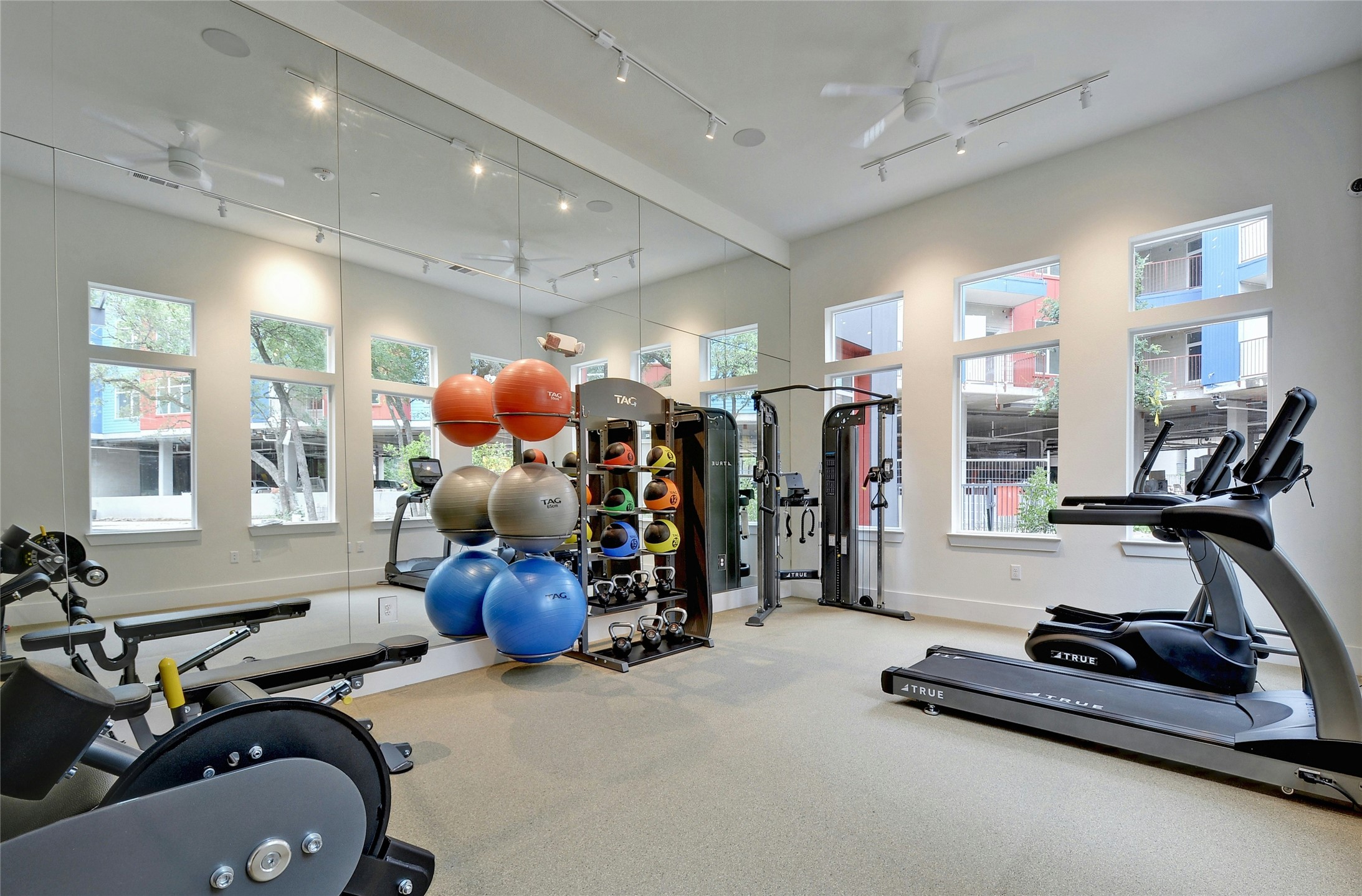 13130 Pond Springs Road, Unit 1105 Austin, TX 78729 - Photo 14 of 22 a room with gym equipment and a large window