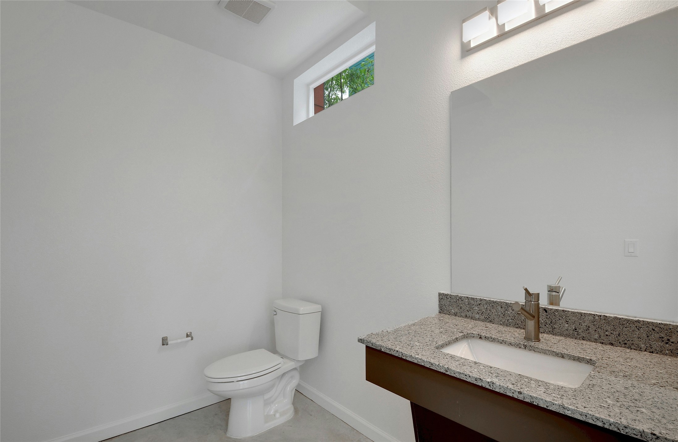 13130 Pond Springs Road, Unit 1105 Austin, TX 78729 - Photo 16 of 22 a bathroom with a granite countertop sink a toilet and a mirror