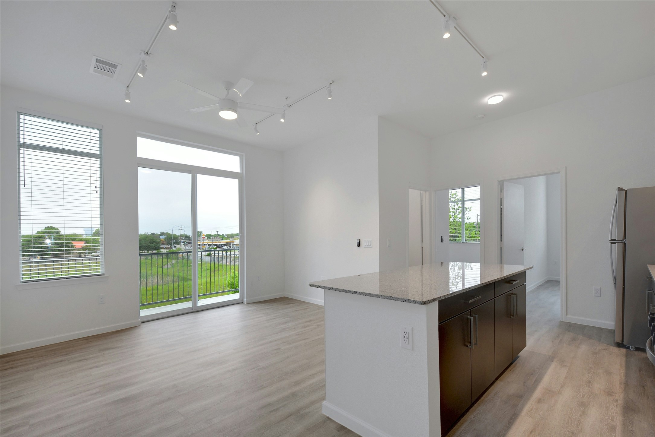13130 Pond Springs Road, Unit 1105 Austin, TX 78729 - Photo 17 of 22 a view of a kitchen island a sink wooden floor and a living room