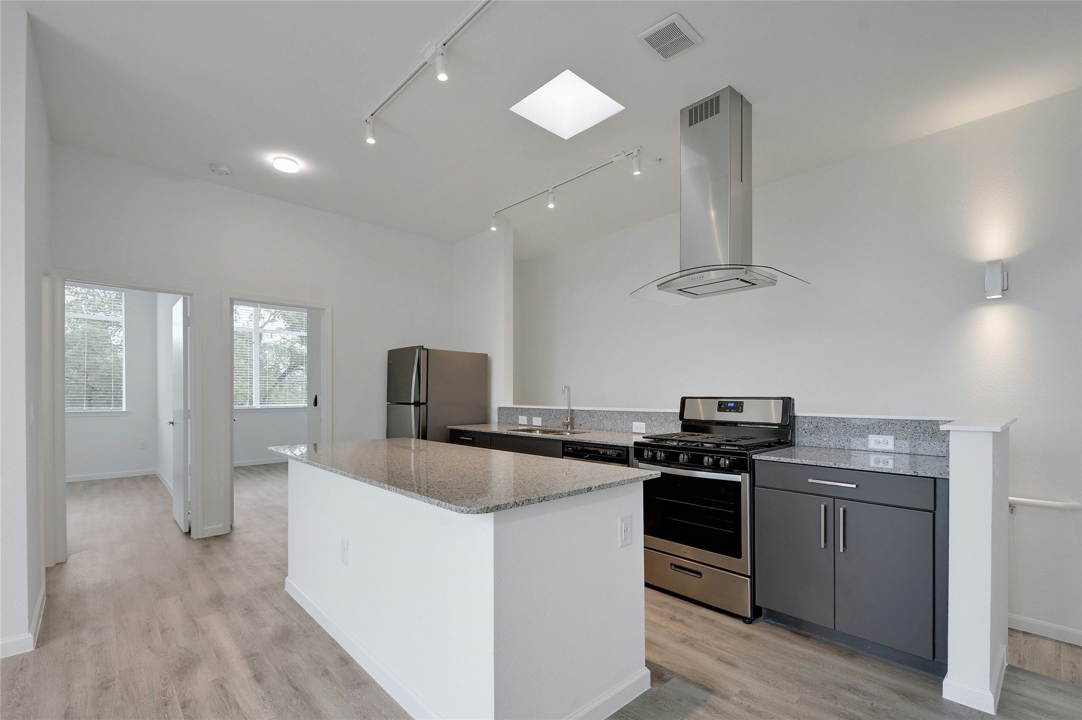 13130 Pond Springs Road, Unit 1105 Austin, TX 78729 - Photo 18 of 22 a kitchen that has a sink stainless steel appliances and cabinets