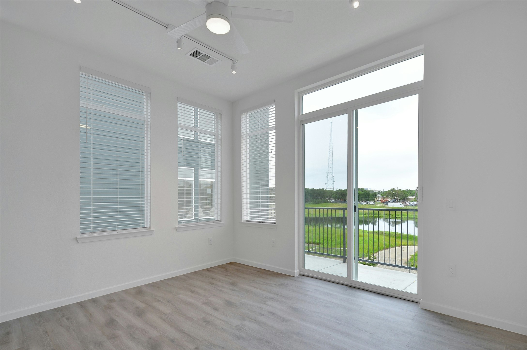 13130 Pond Springs Road, Unit 1105 Austin, TX 78729 - Photo 19 of 22 a view of an empty room with wooden floor and a window