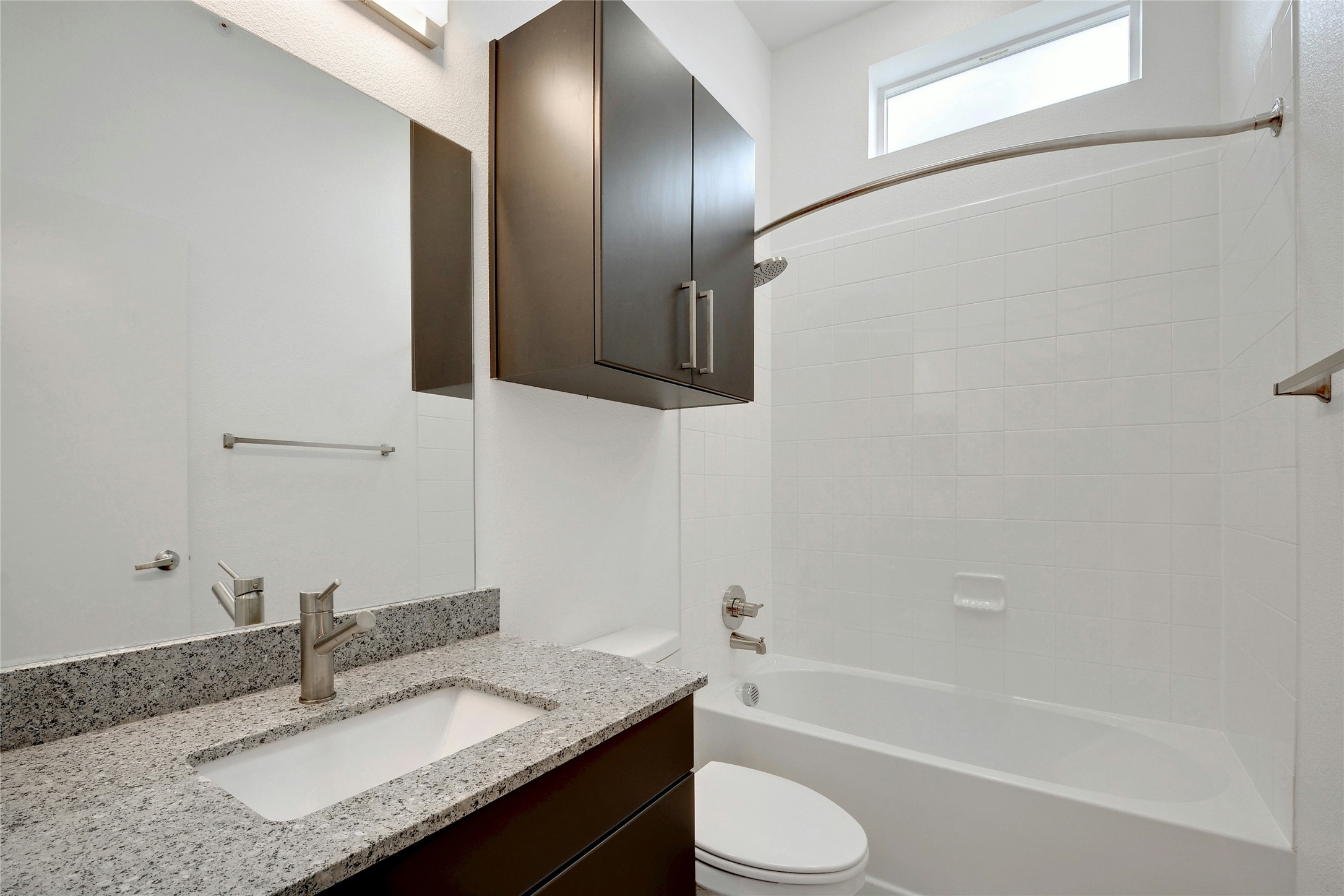13130 Pond Springs Road, Unit 1105 Austin, TX 78729 - Photo 21 of 22 a bathroom with a granite countertop sink toilet and shower