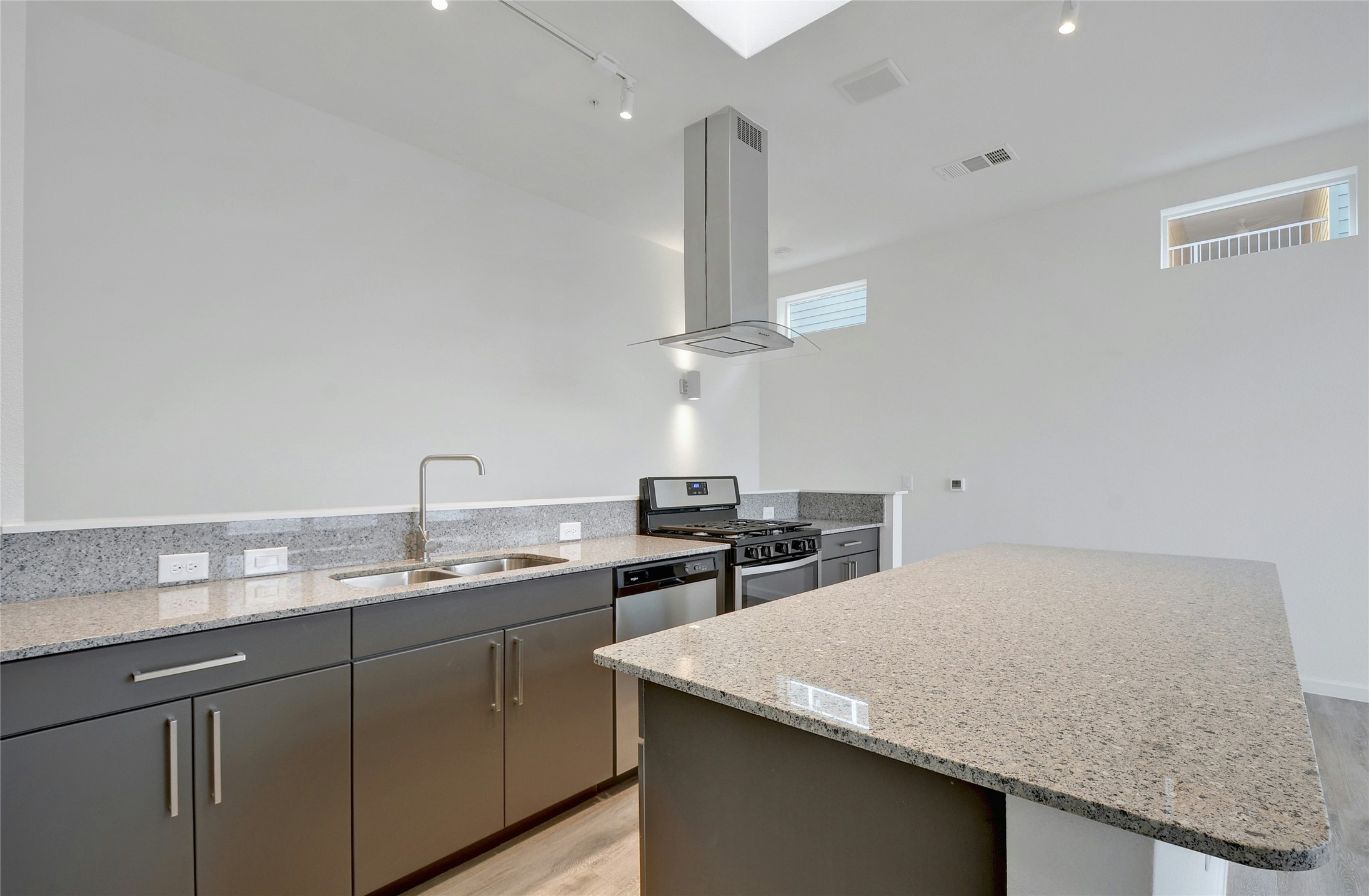 13130 Pond Springs Road, Unit 1105 Austin, TX 78729 - Photo 4 of 22 a kitchen with a sink a stove and cabinets