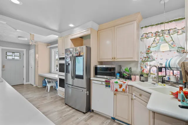 a kitchen with stainless steel appliances a refrigerator sink and cabinets