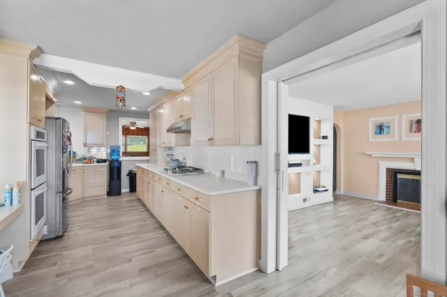 a large kitchen with cabinets and stainless steel appliances