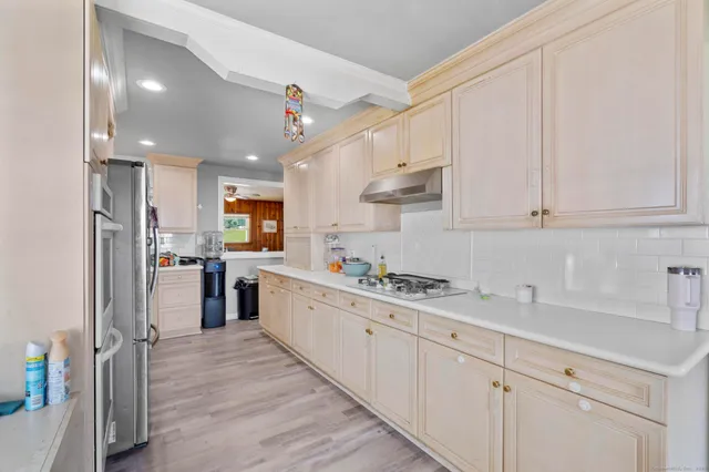 a kitchen with stainless steel appliances granite countertop a sink and cabinets
