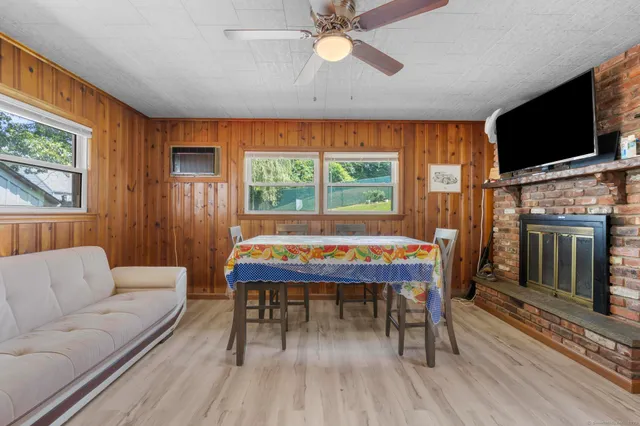 a dining room with furniture window and wooden floor