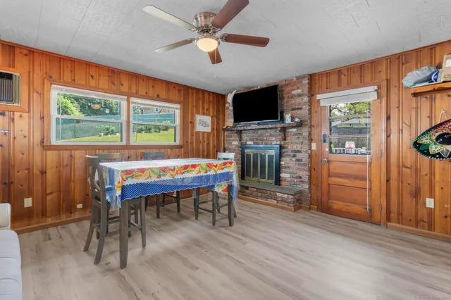 a living room with furniture a fireplace and a large window