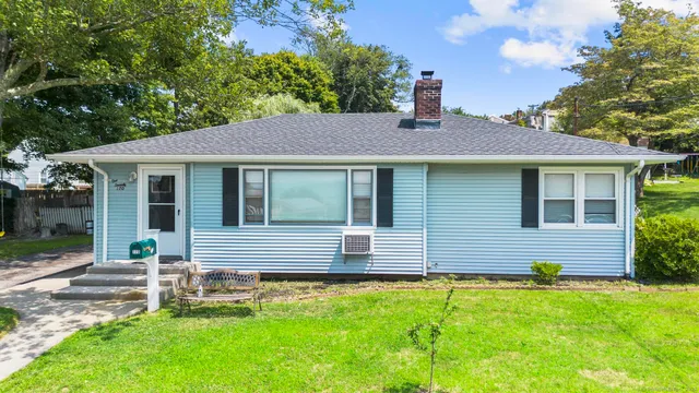 a backyard of a house with table and chairs