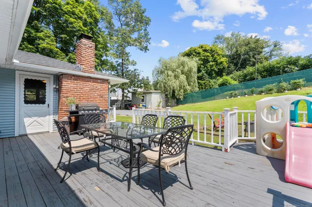 a view of a deck with chairs and a yard