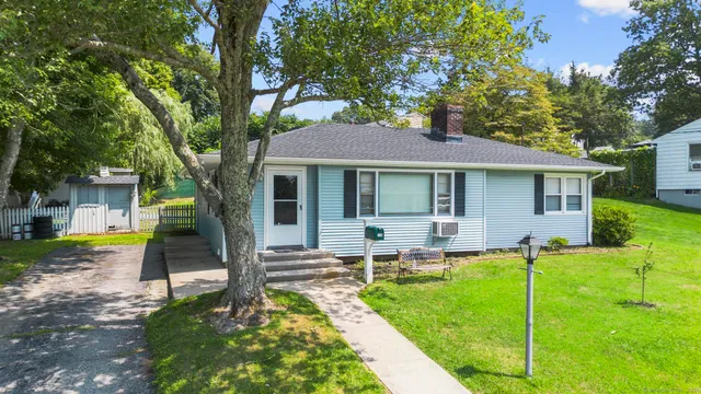 a house view with a sitting space and garden