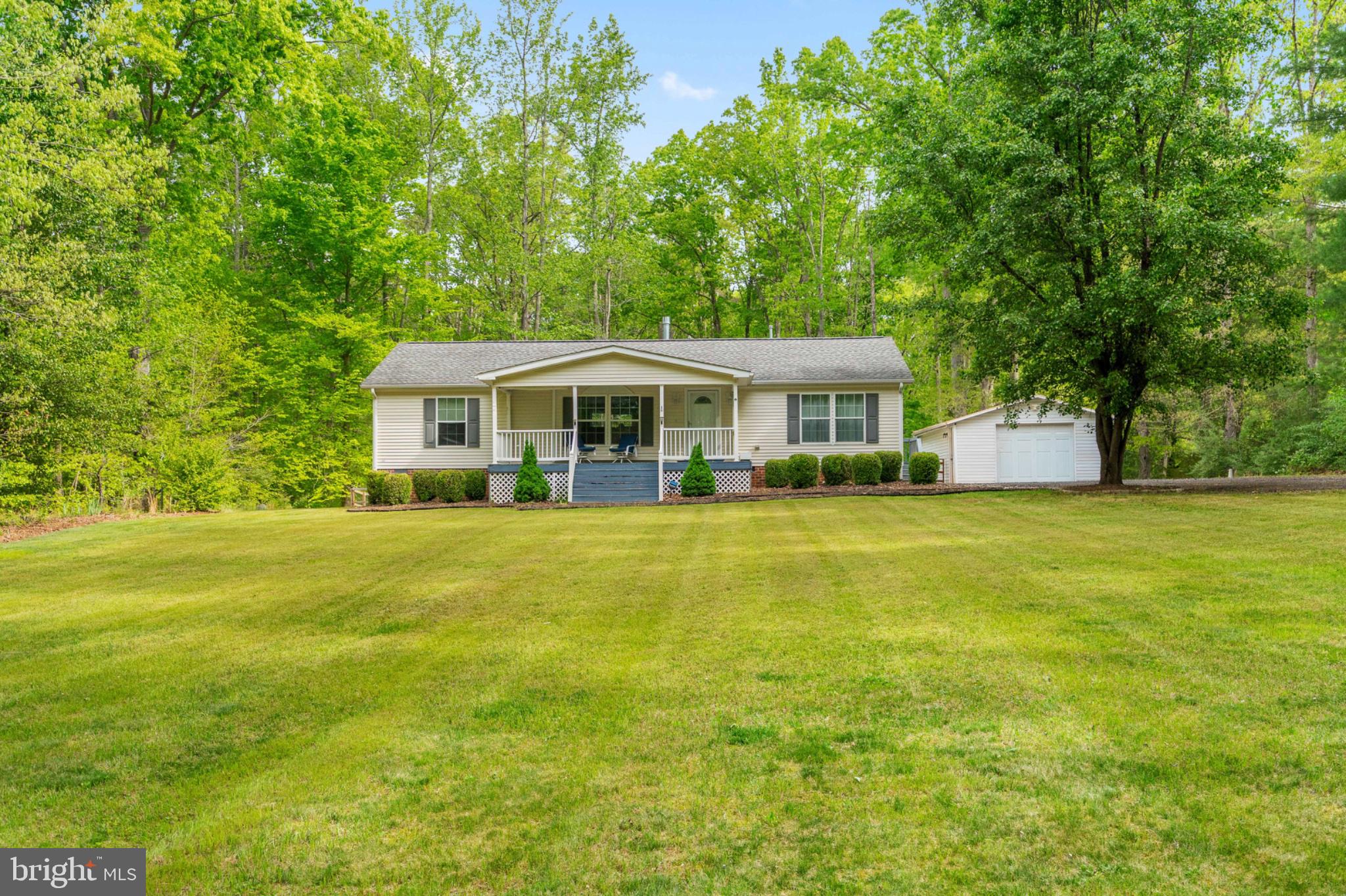 2319 Sizer Road Beaverdam, VA 23015 - Photo 4 of 61 a front view of a house with a yard table and chairs