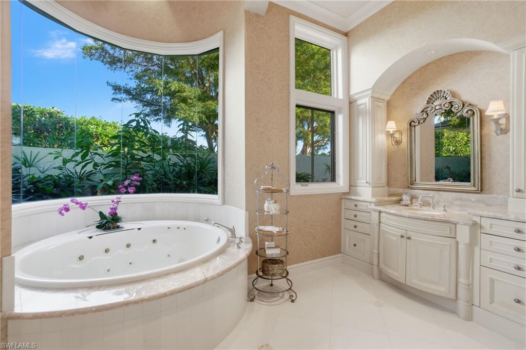 28920 Cavell Terrace Naples, FL 34119 - Photo 13 of 50 a bathroom with a tub a sink and mirror
