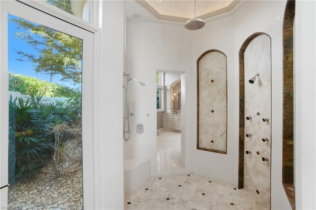 28920 Cavell Terrace Naples, FL 34119 - Photo 14 of 50 a bathroom with a glass shower door and a sink