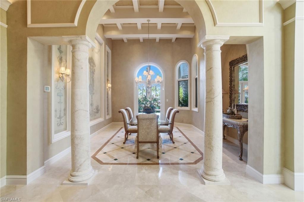 28920 Cavell Terrace Naples, FL 34119 - Photo 15 of 50 a view of a hallway with a dining table and chairs