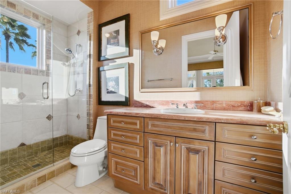 28920 Cavell Terrace Naples, FL 34119 - Photo 29 of 50 a bathroom with a granite countertop toilet sink and a mirror