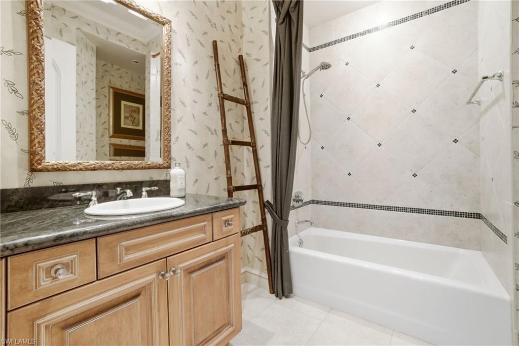 28920 Cavell Terrace Naples, FL 34119 - Photo 31 of 50 a bathroom with a granite countertop sink and a bathtub