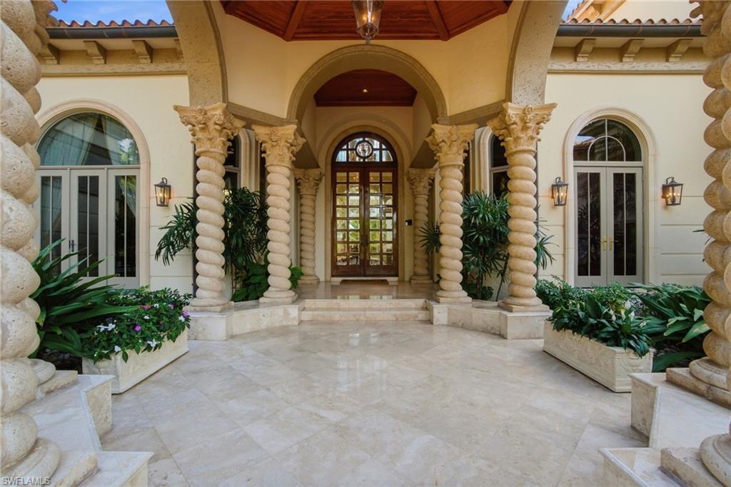 28920 Cavell Terrace Naples, FL 34119 - Photo 6 of 50 a front view of a house with a garden