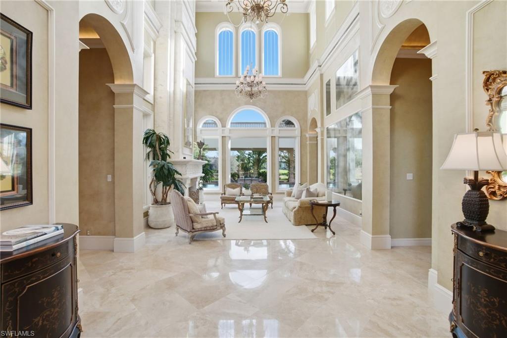 28920 Cavell Terrace Naples, FL 34119 - Photo 7 of 50 a living room with furniture and floor to ceiling windows