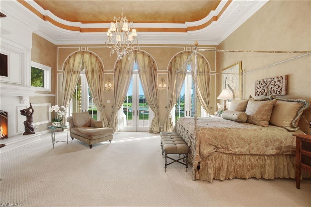 28920 Cavell Terrace Naples, FL 34119 - Photo 10 of 50 a bedroom with furniture and a large mirror