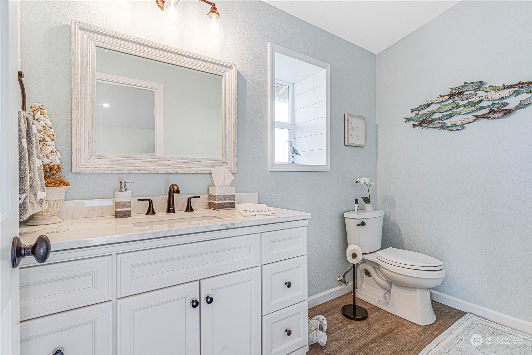 2942 Steamboat Island Road Northwest Olympia, WA 98502 - Photo 30 of 40 a bathroom with a toilet a sink and mirror