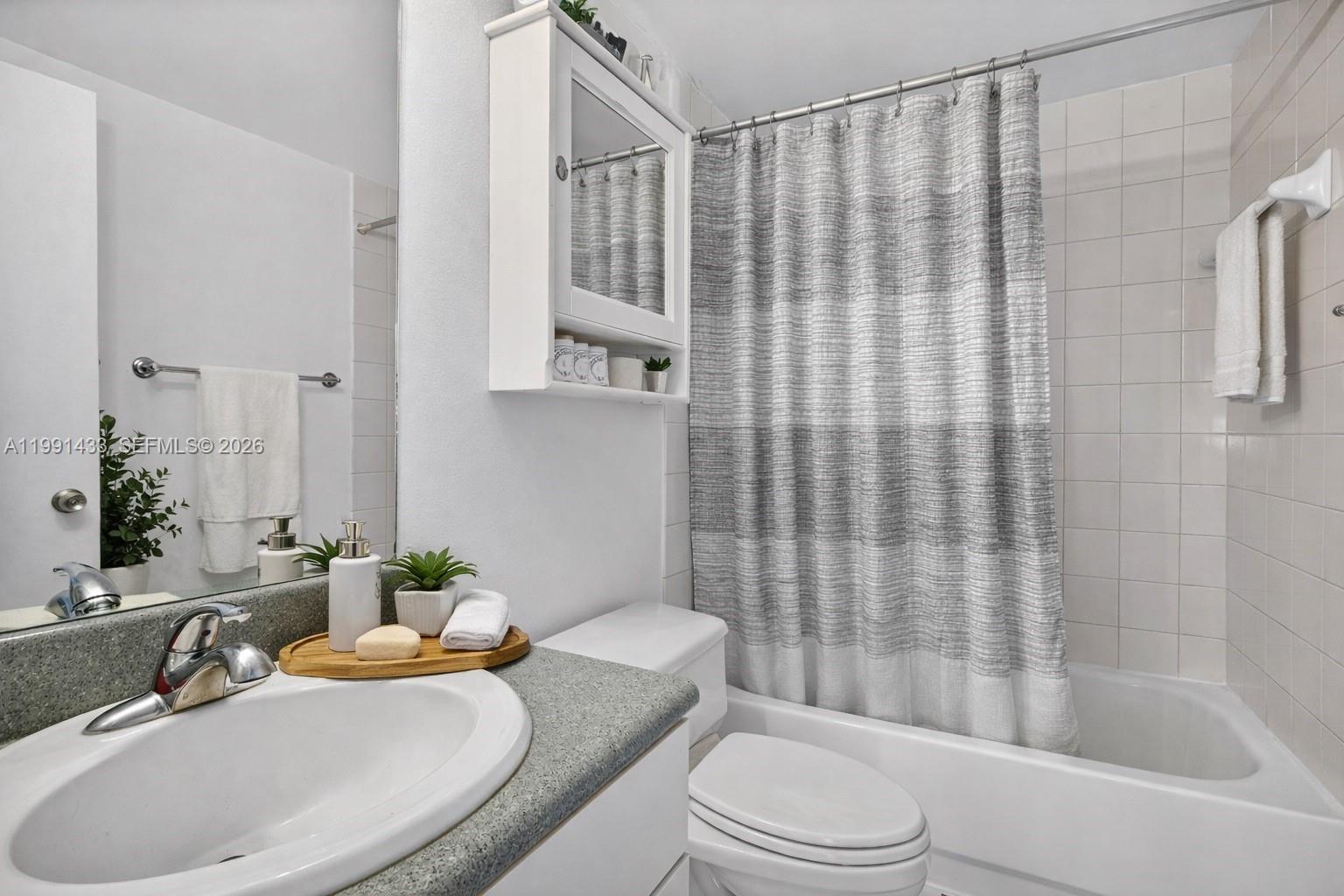 701 Brickell Key Boulevard, Unit 1108 Miami, FL 33131 - Photo 4 of 13 a bathroom with a sink toilet and shower
