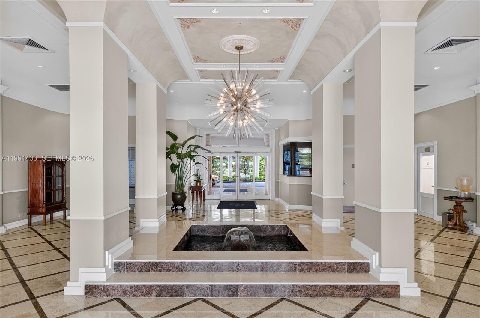 701 Brickell Key Boulevard, Unit 1108 Miami, FL 33131 - Photo 10 of 13 a living room with fireplace furniture and a chandelier