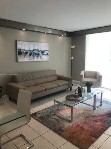 a living room with furniture and a rug