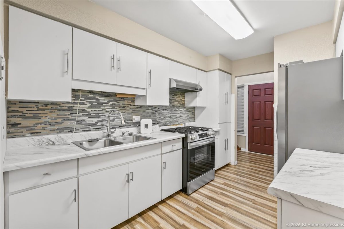 18847 May Avenue Homewood, IL 60430 - Photo 10 of 26 a kitchen with a sink stove and cabinets