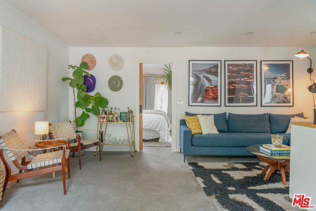 a large bed sitting in a bedroom next to a window