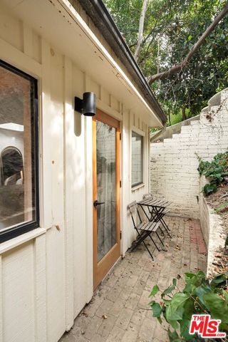 a large bed sitting in a bedroom next to a lamp