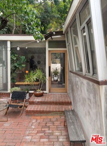 a patio with wooden table and chairs