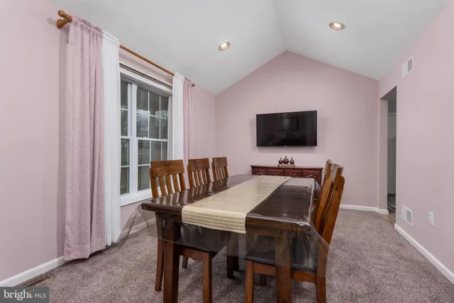 a view of a dining room that has a table and chairs