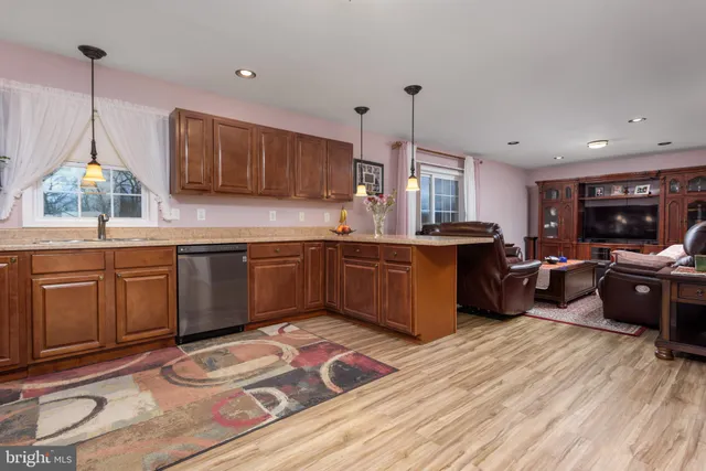 a kitchen with stainless steel appliances kitchen island granite countertop a sink stove and cabinets