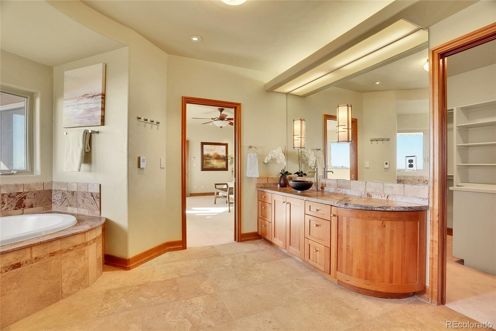 6057 Red Hill Road Boulder, CO 80302 - Photo 19 of 41 a large bathroom with a granite countertop double vanity sink a mirror and a shower