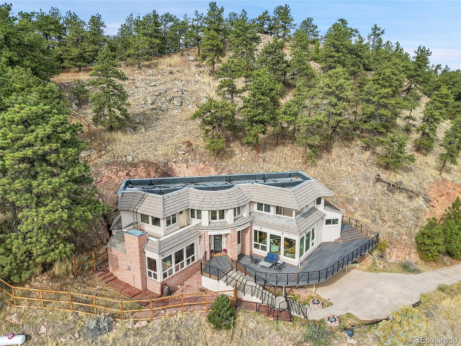6057 Red Hill Road Boulder, CO 80302 - Photo 32 of 41 a large building with a big yard and large trees