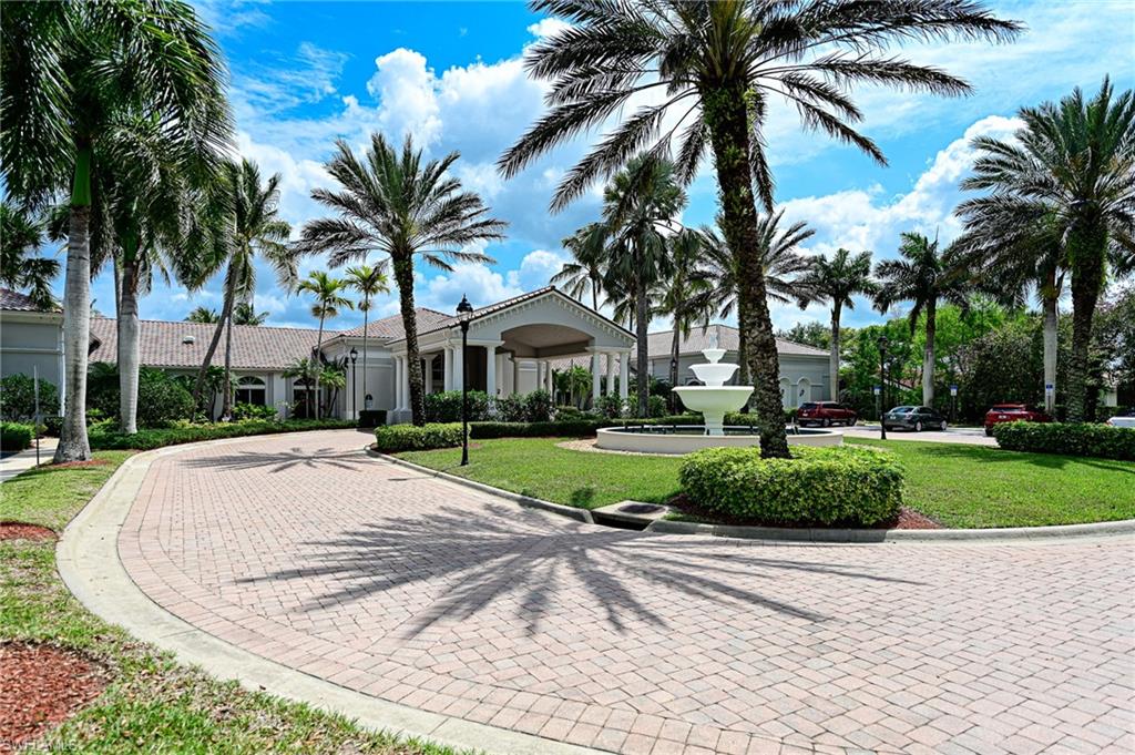 9290 Springview Loop Estero, FL 33928 - Photo 17 of 25 a view of a white house with a yard and palm trees
