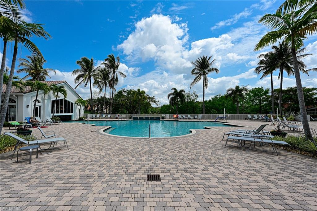 9290 Springview Loop Estero, FL 33928 - Photo 18 of 25 a view of a swimming pool with a table and chairs