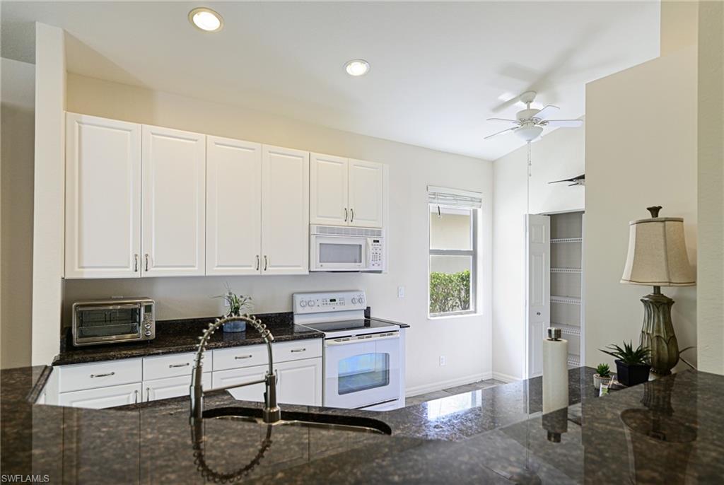 9290 Springview Loop Estero, FL 33928 - Photo 6 of 25 a workspace with white cabinets and white appliances