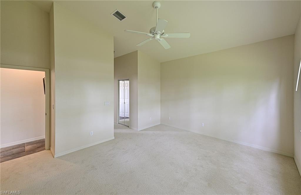 9290 Springview Loop Estero, FL 33928 - Photo 9 of 25 an empty room with a ceiling fan and a window