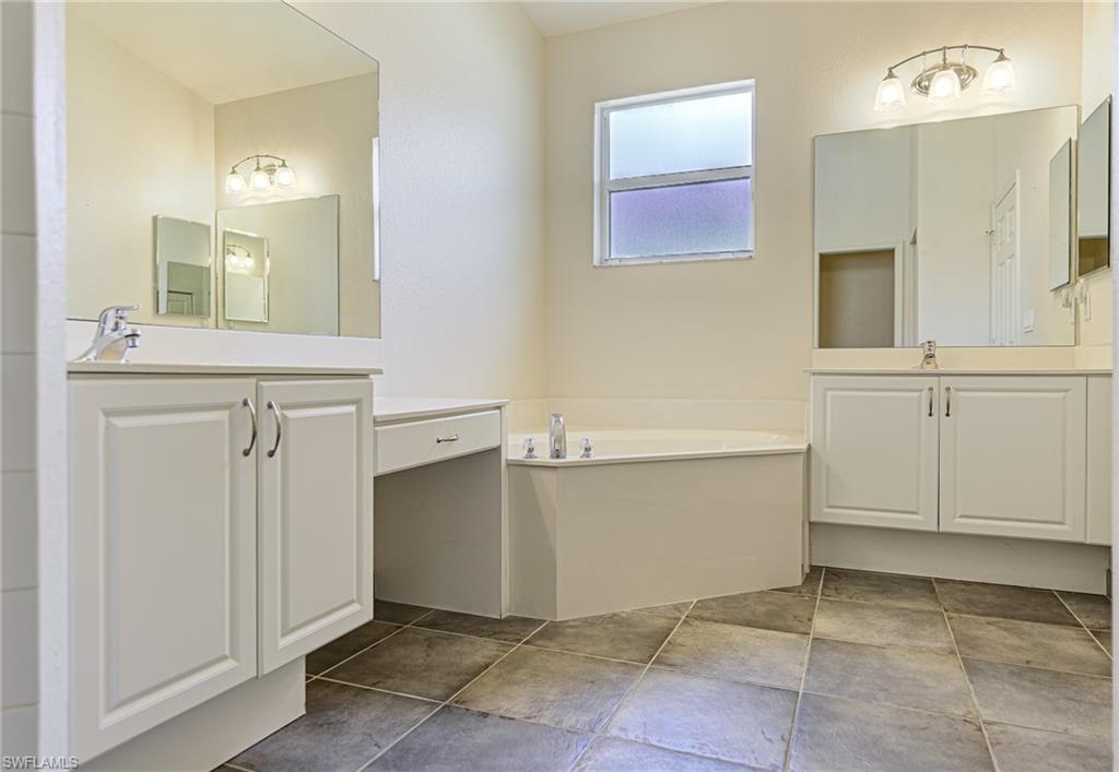 9290 Springview Loop Estero, FL 33928 - Photo 10 of 25 a bathroom with a sink vanity and mirror