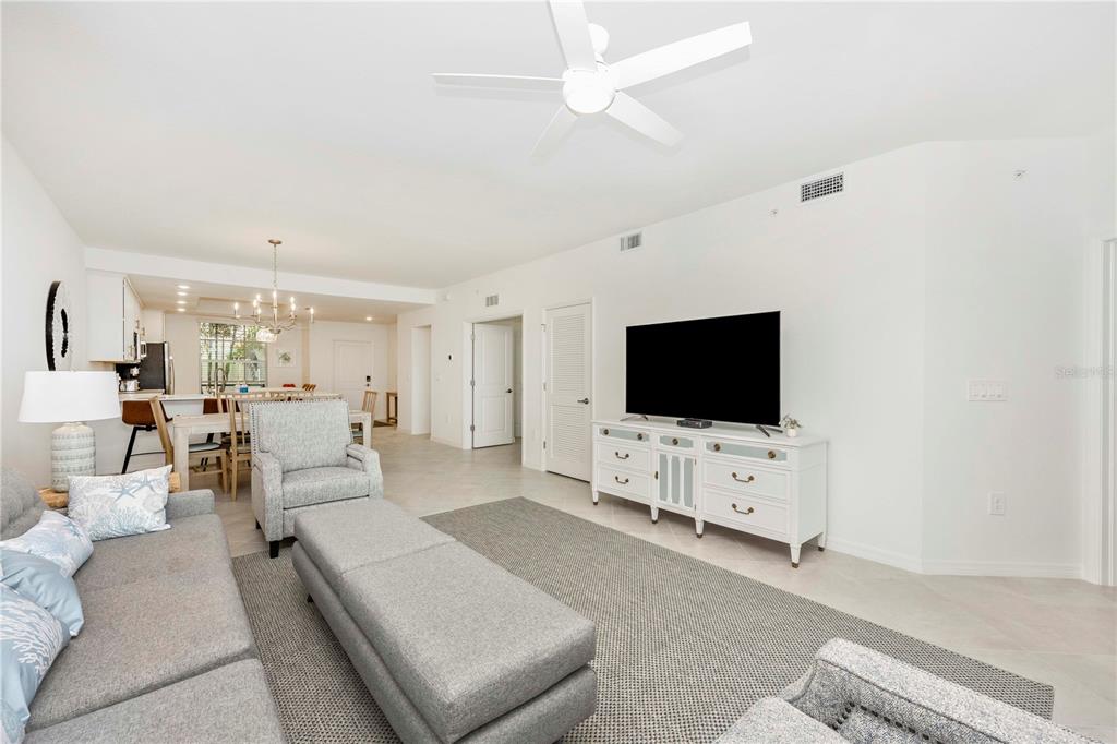 17500 Opal Sand Drive, Unit 101 Venice, FL 34293 - Photo 20 of 98 a living room with furniture and a flat screen tv