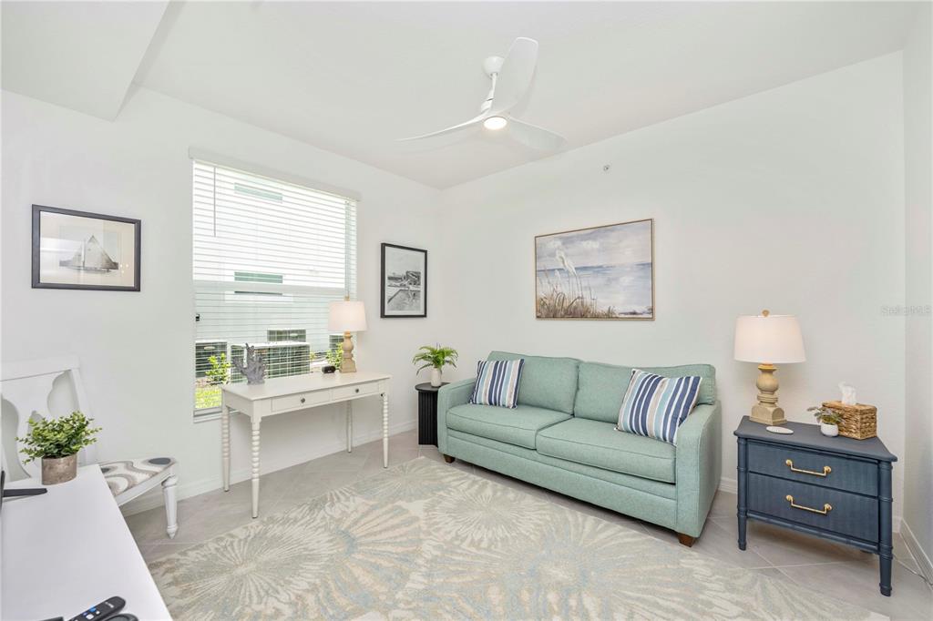 17500 Opal Sand Drive, Unit 101 Venice, FL 34293 - Photo 21 of 98 a living room with furniture and a large window
