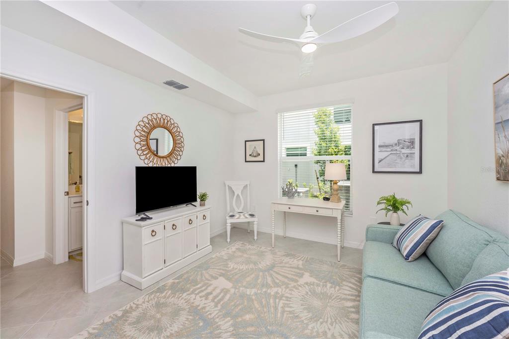 17500 Opal Sand Drive, Unit 101 Venice, FL 34293 - Photo 23 of 98 a living room with furniture and a flat screen tv