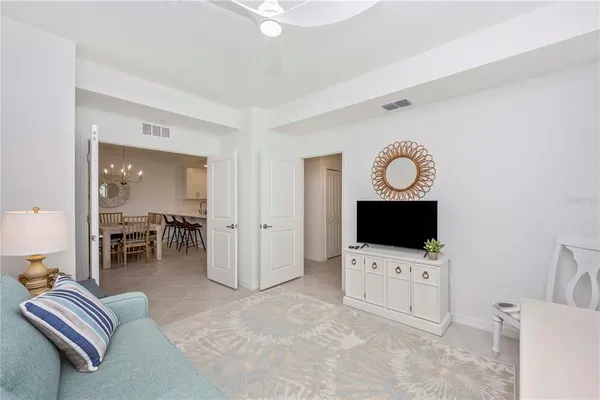 a living room with furniture and a floor to ceiling window